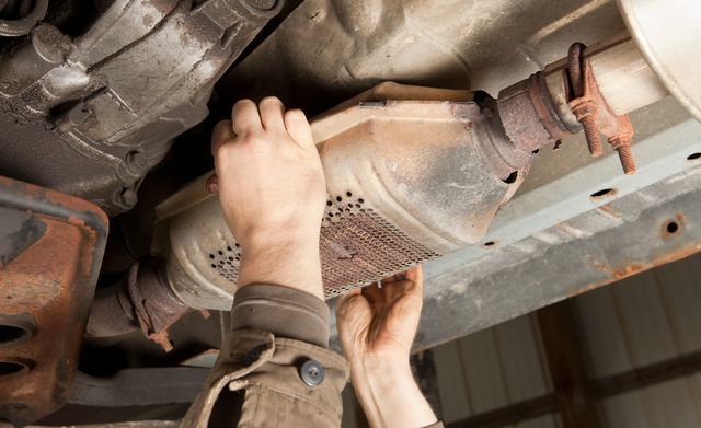 catalytic converter removal at a salvage yard royalty free image 1615767464